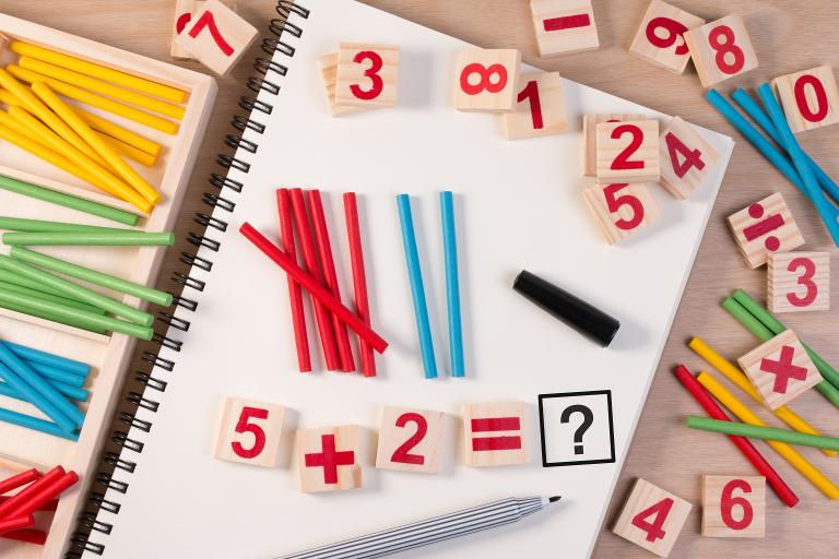 Educational kids math toy with wooden number counters and sticks.