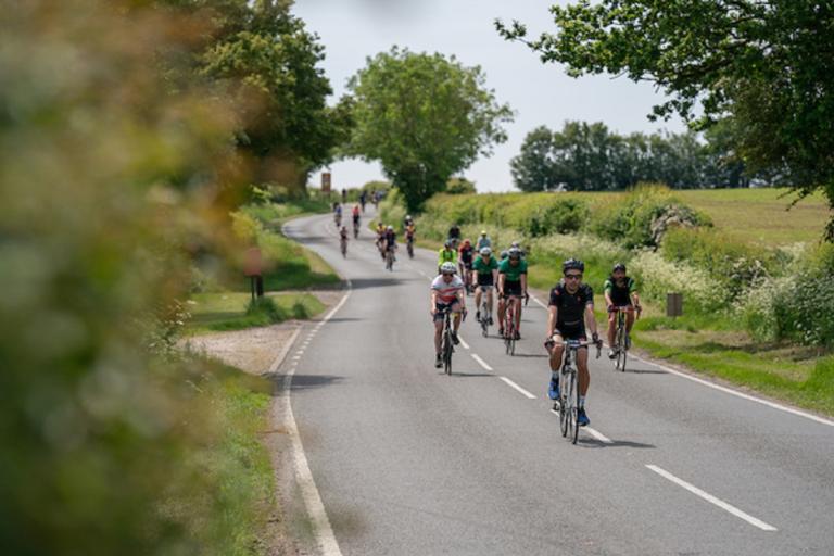 Group of cyclists on the road in the countryside taking part in RideLondon-Essex