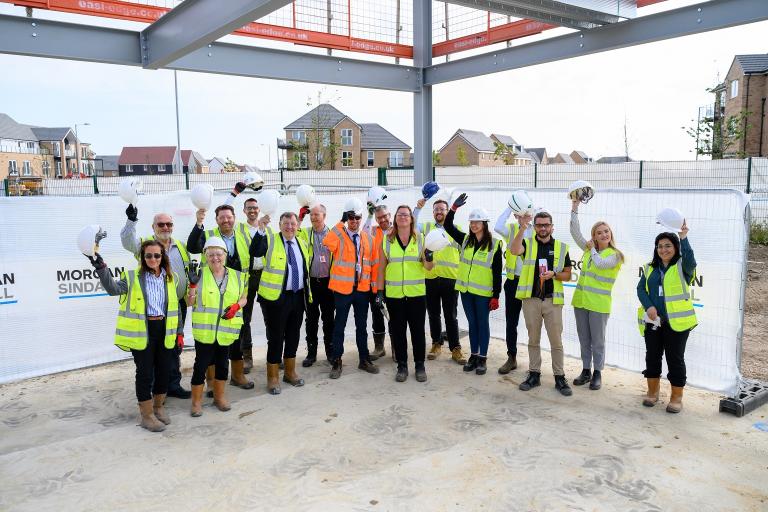 A group of people in high-visibility jackets and hard hats on site at the new Maldon primary school.
