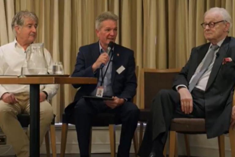 Tony Juniper CBE, Councillor Peter Schwier, and Lord Deben sit together on stage during the summit.