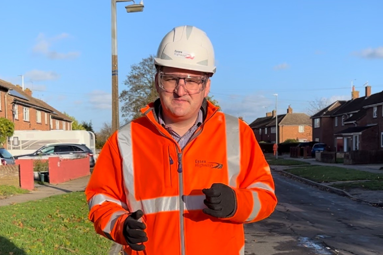 A picture of Councillor Tom Cunningham wearing an orange high-visibility jacket and white hard-hat
