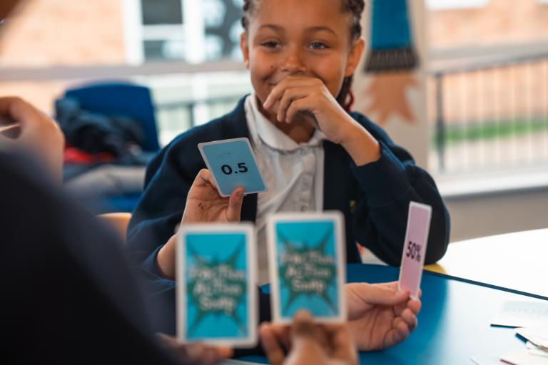 Children playing a game with numbered cards