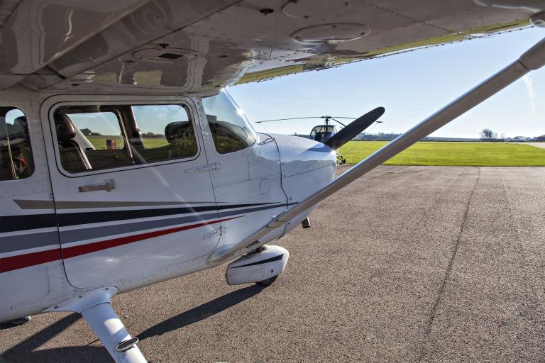 A close up shot taken from under the wing of a small private aircraft