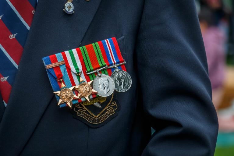 Close-up of World War II medals pinned to the blazer of a veteran.