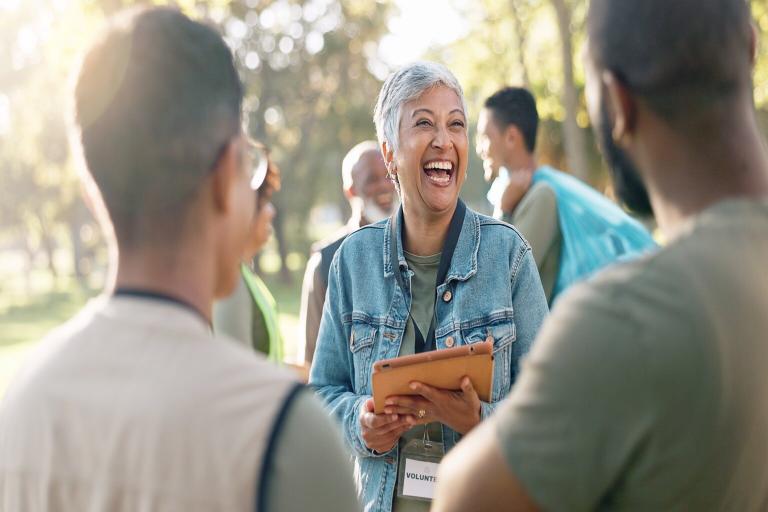 A lady smilinghelping the community