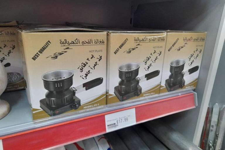 Boxed hotplates lined on a shop shelf.