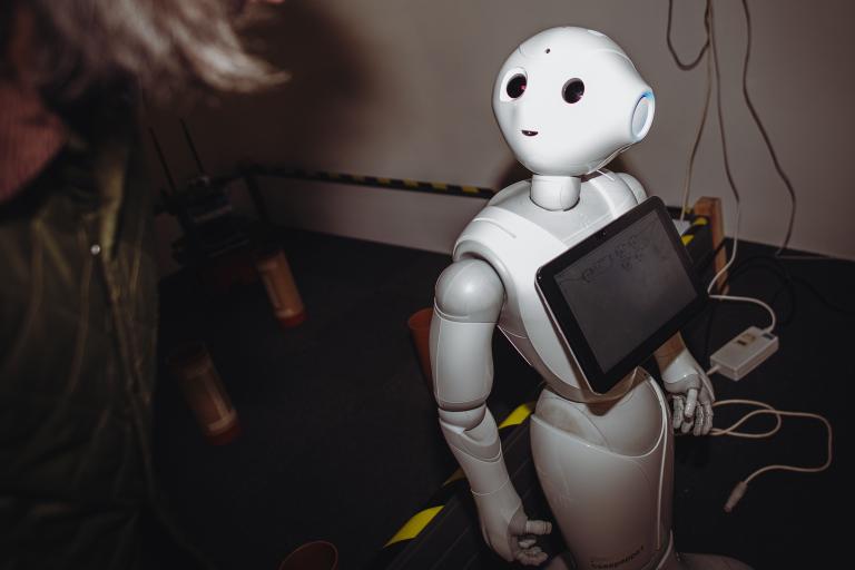 A photograph of a robot with a screen on the front of its chest. 
