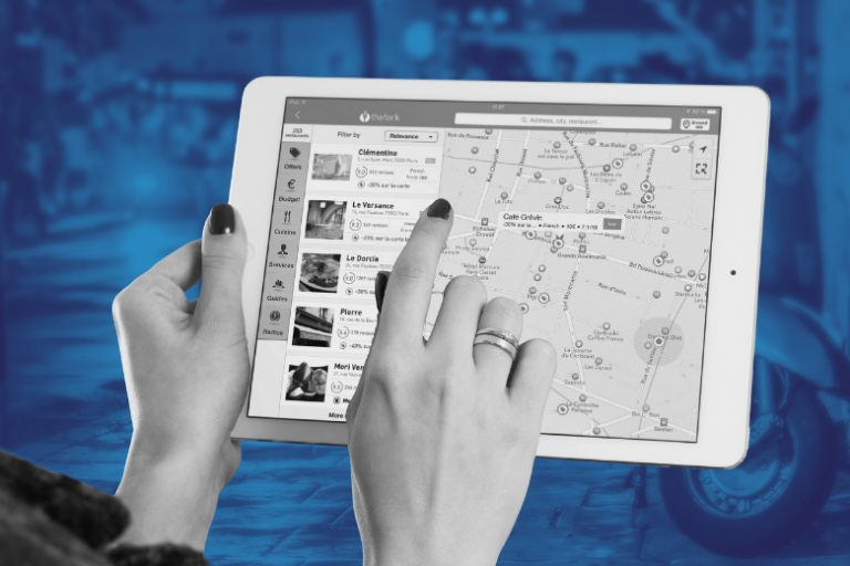 hand holding tablet and viewing a map