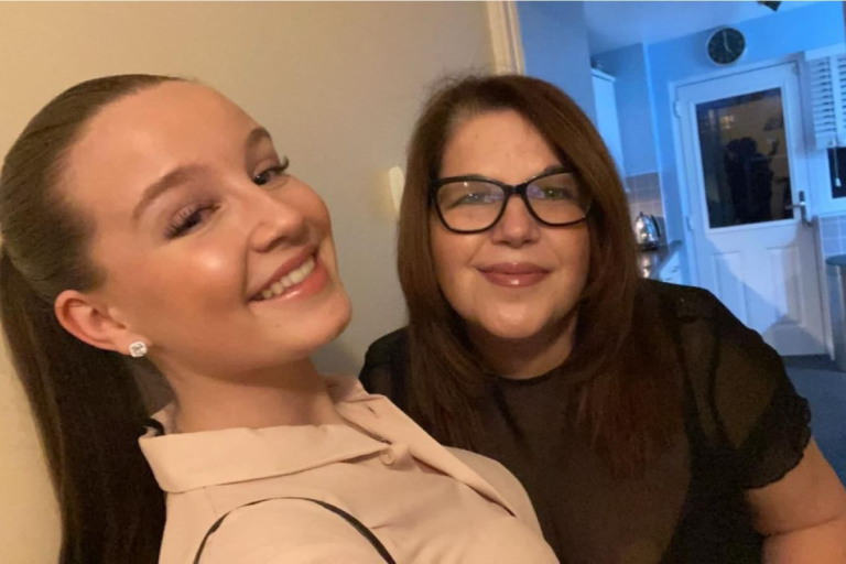 Two women - Cara and Charlotte - standing side by side. They are both smiling.
