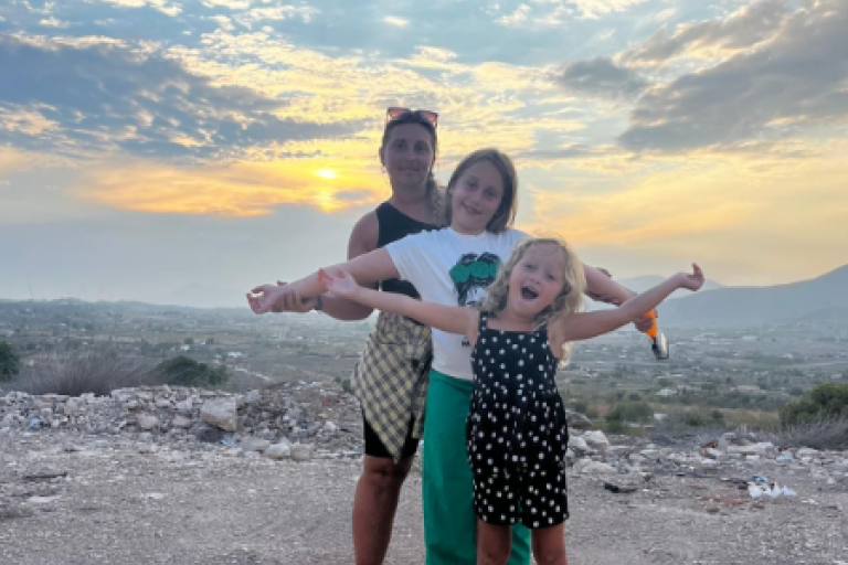Laura and her daughters on the beach