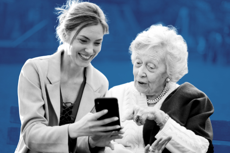 A young women and elderly women looking at a mobile phone