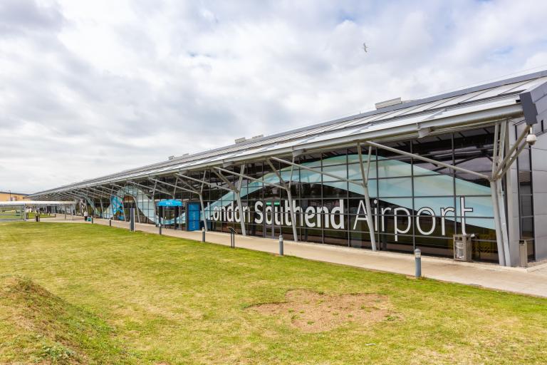 Large glass airport terminal with grass in front and the words London Southend Airport.