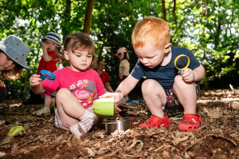 Young children playing outside in an early years setting.