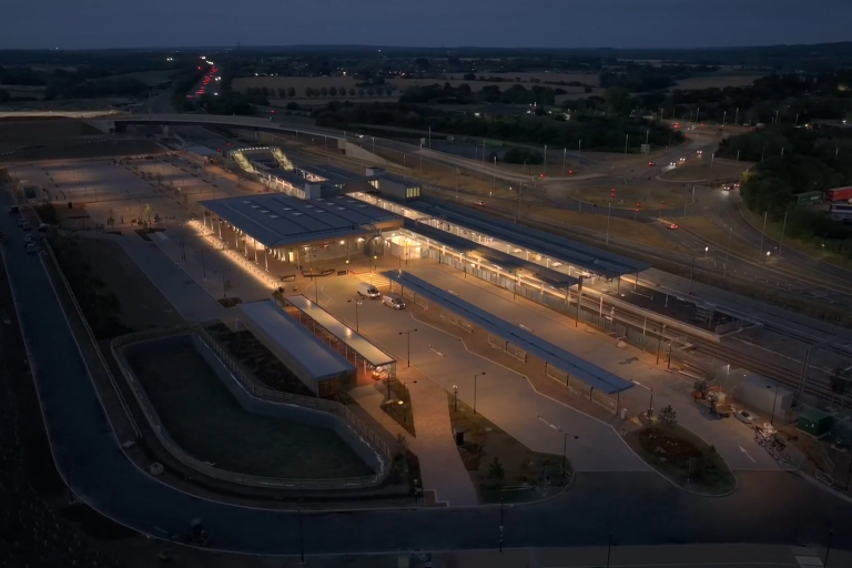 Aerial shot of a new train station lit up at night.