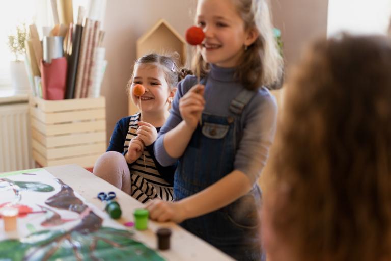 Two young girls working on some arts and crafts.