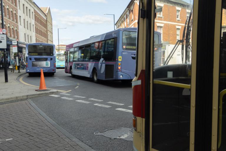 Three buses parked up on a road in Colchester.