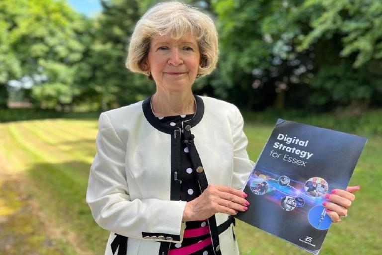 Cllr Lesley Wagland OBE holding a copy of our new Digital Strategy for Essex